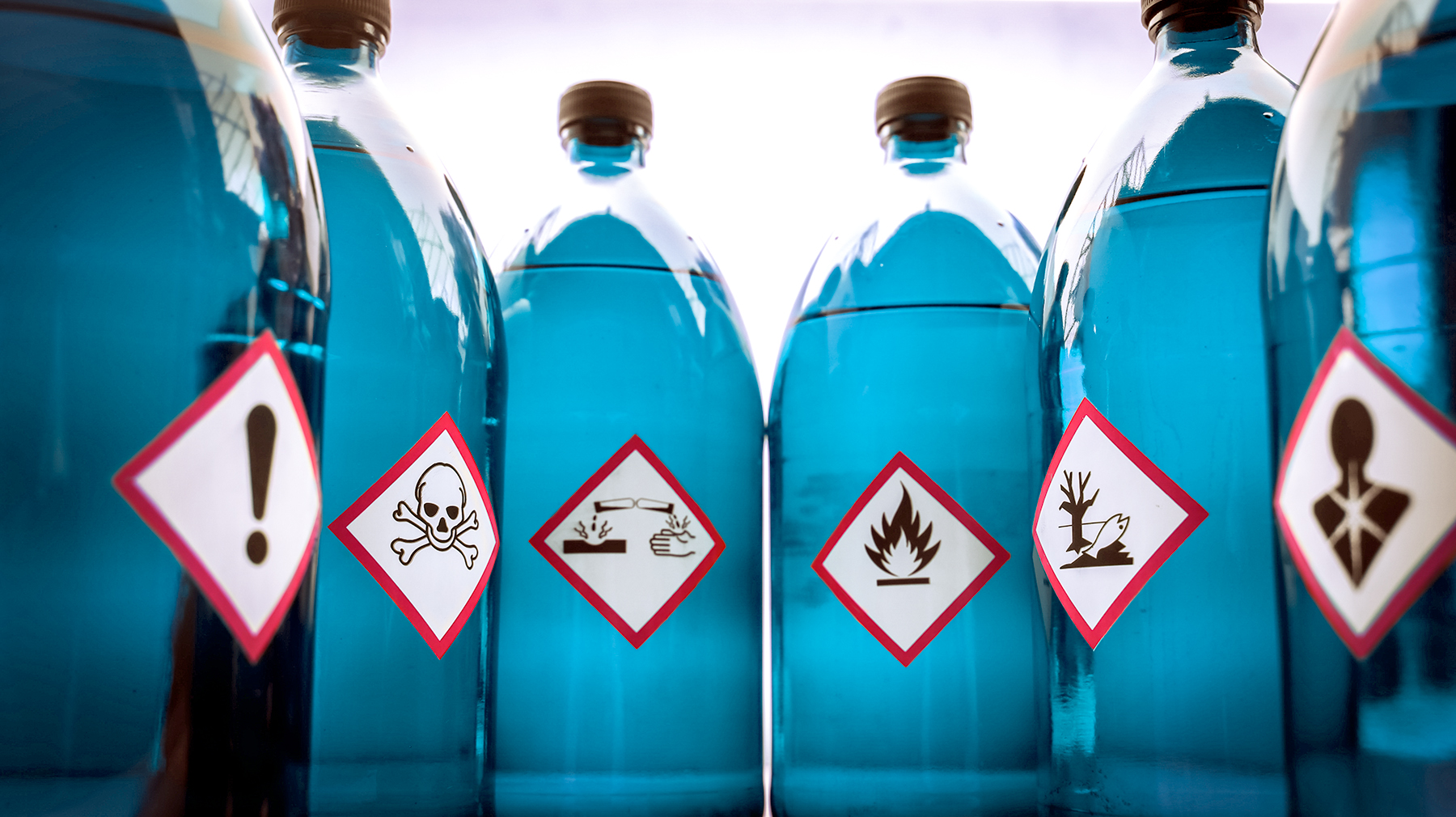Chemical Hazard Labels on Blue Bottles