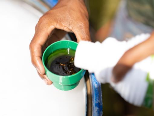 Man pouring and mixing fungicidal plant protection product.