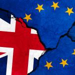 GB & EU flags on cracked concrete.